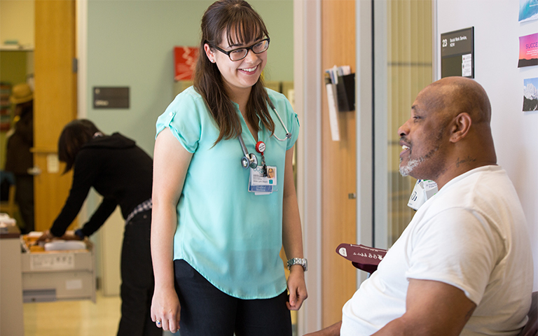 Medical Student talks to patient in clinic