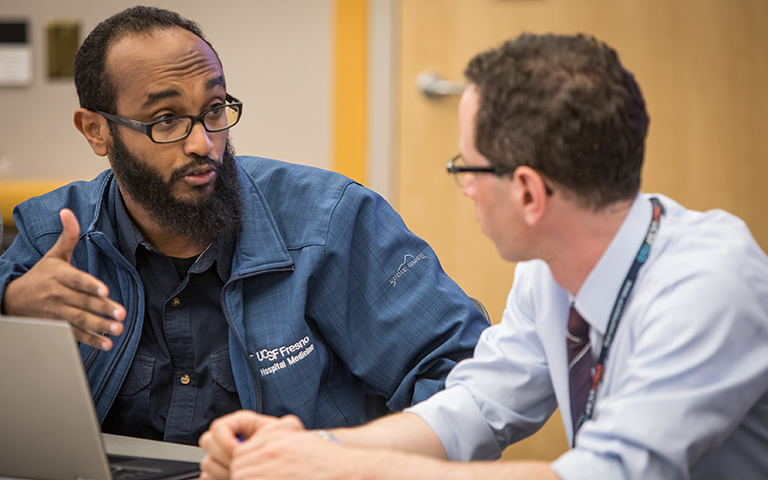 Seated next to each other in discussion, on left is Mohammed Elhassan, MD and on the right is Glenn Rosenbluth, MD; photo by Elisabeth Fall