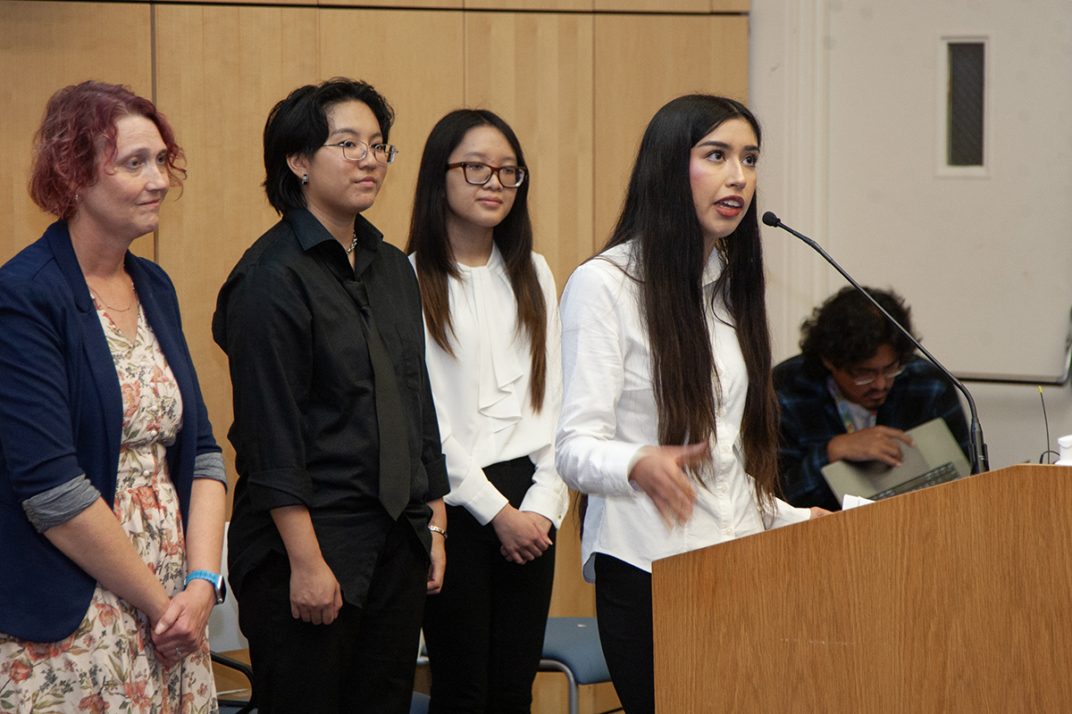 Group of people presenting at podium