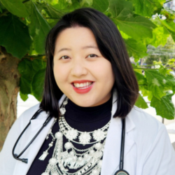 Headshot of person in white coat