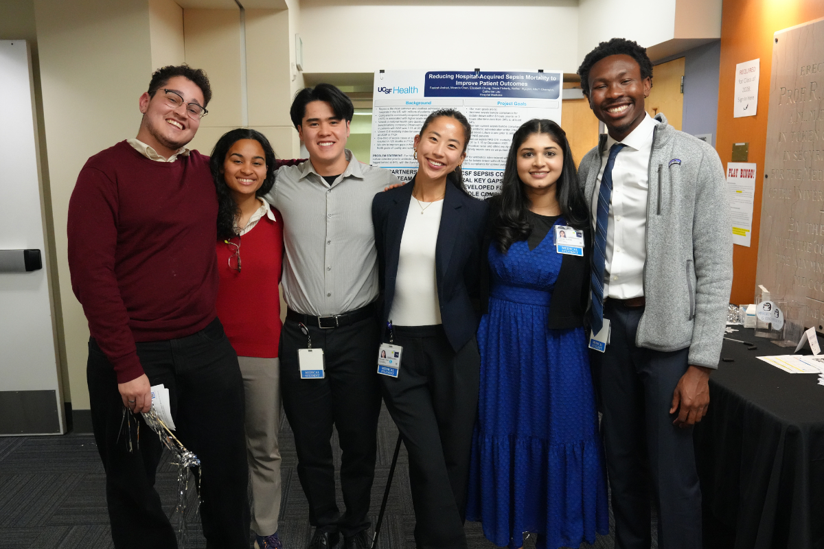 Medical students pose with a poster