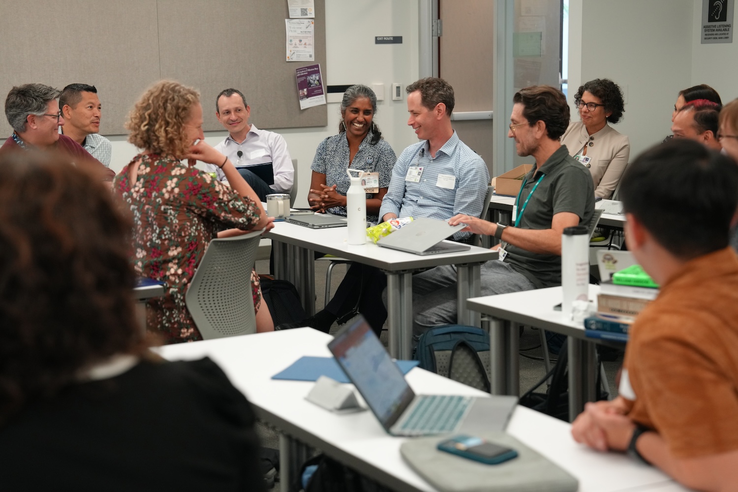 cheerful faculty gathered around conference tables