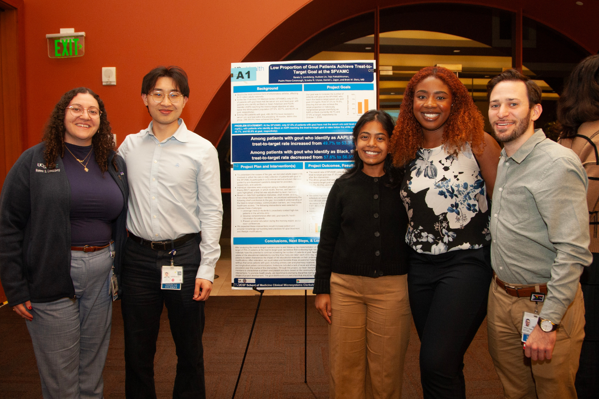 A group of students pose during a poster session