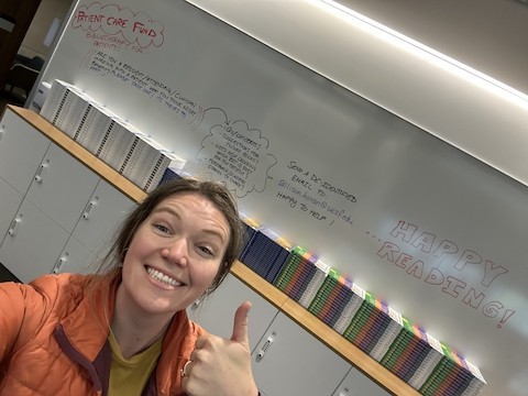 Dr. Allison Horan gives thumbs up in new library