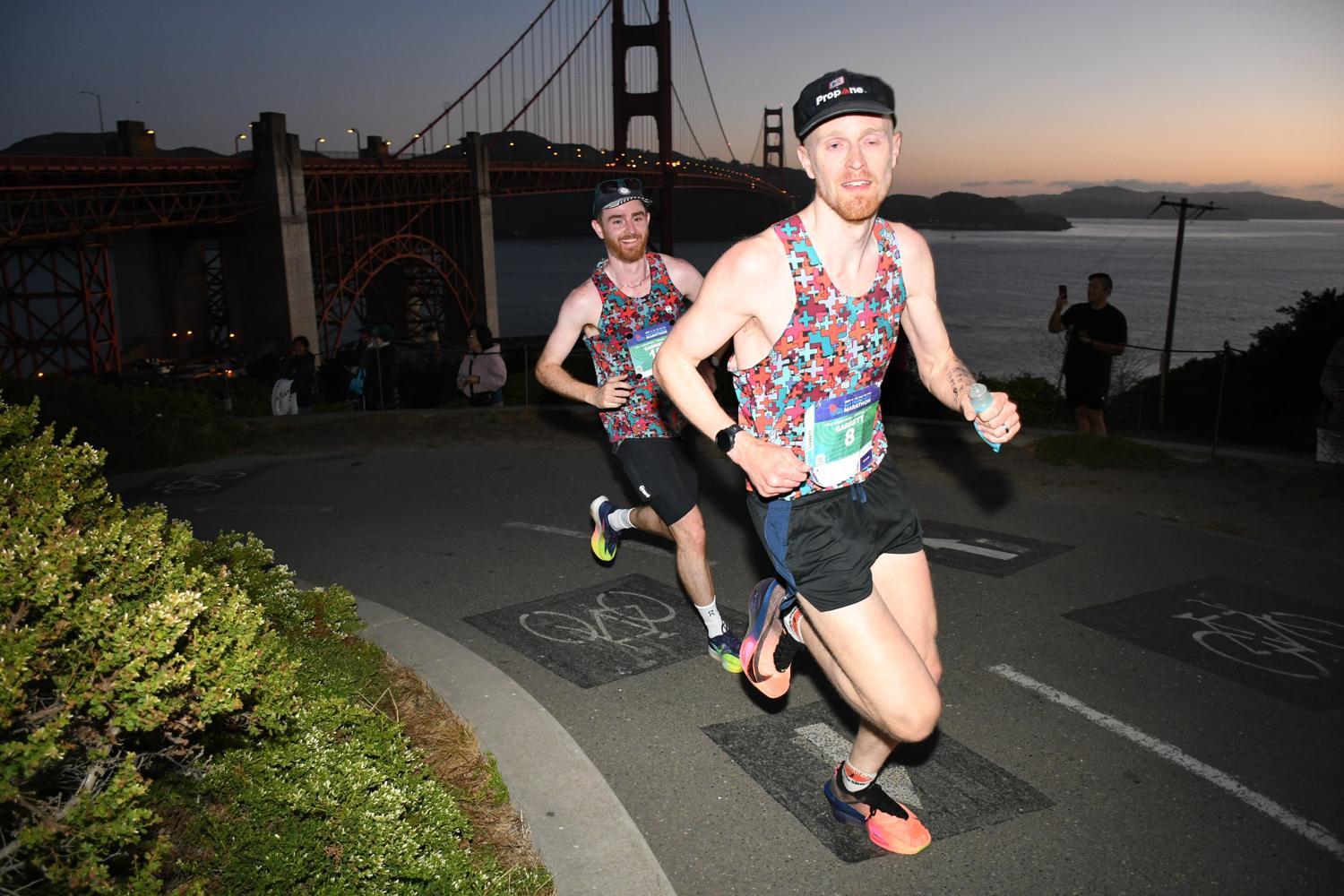 Dr. Patrick runs at dawn with the silhouette of the Golden Gate Bridge behind him.