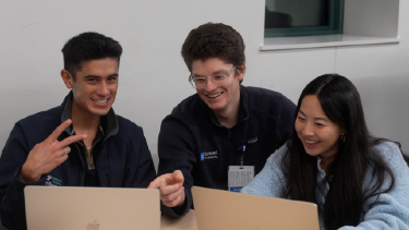 Medical students working together on laptops