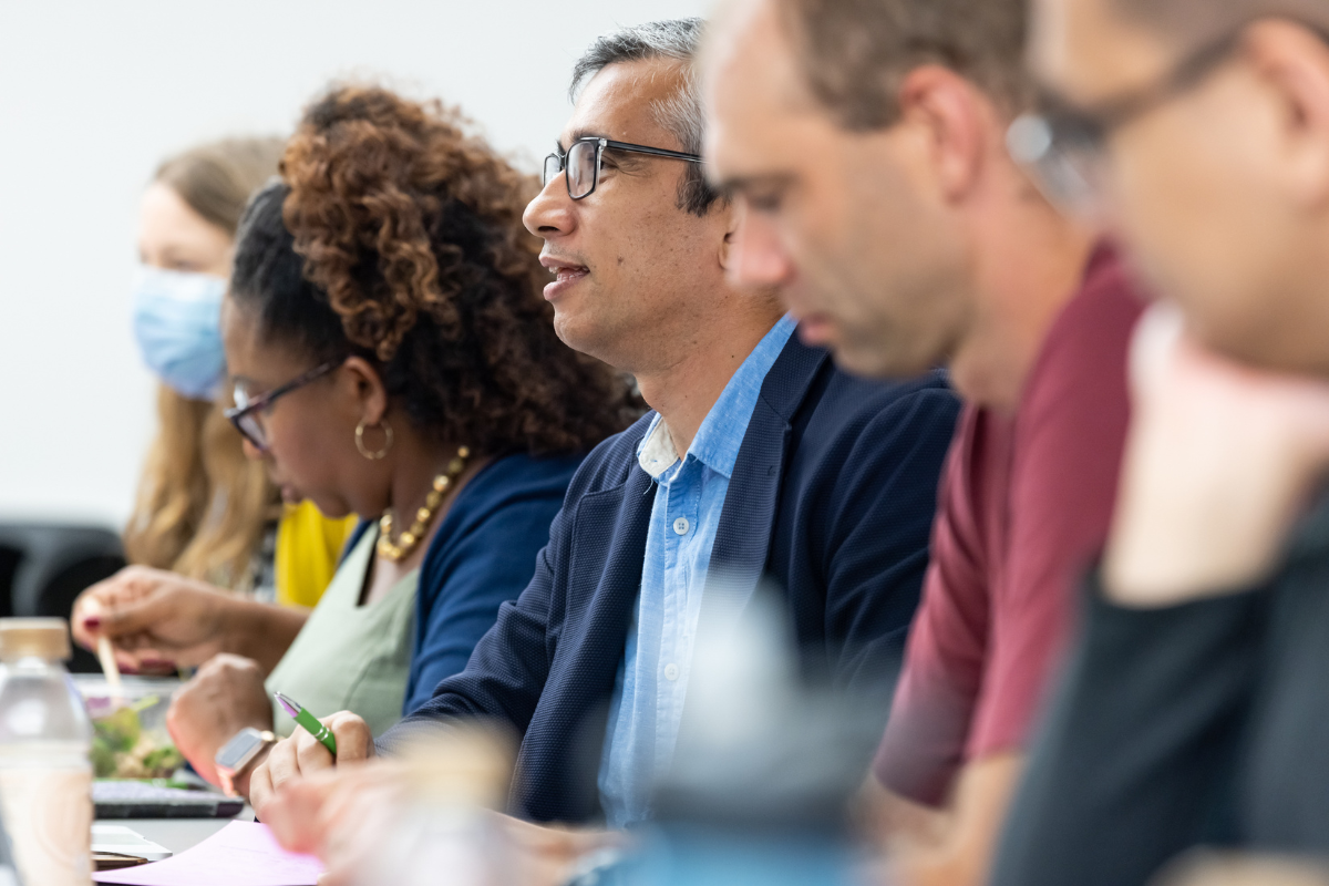 A row of people seated participating in a discussion