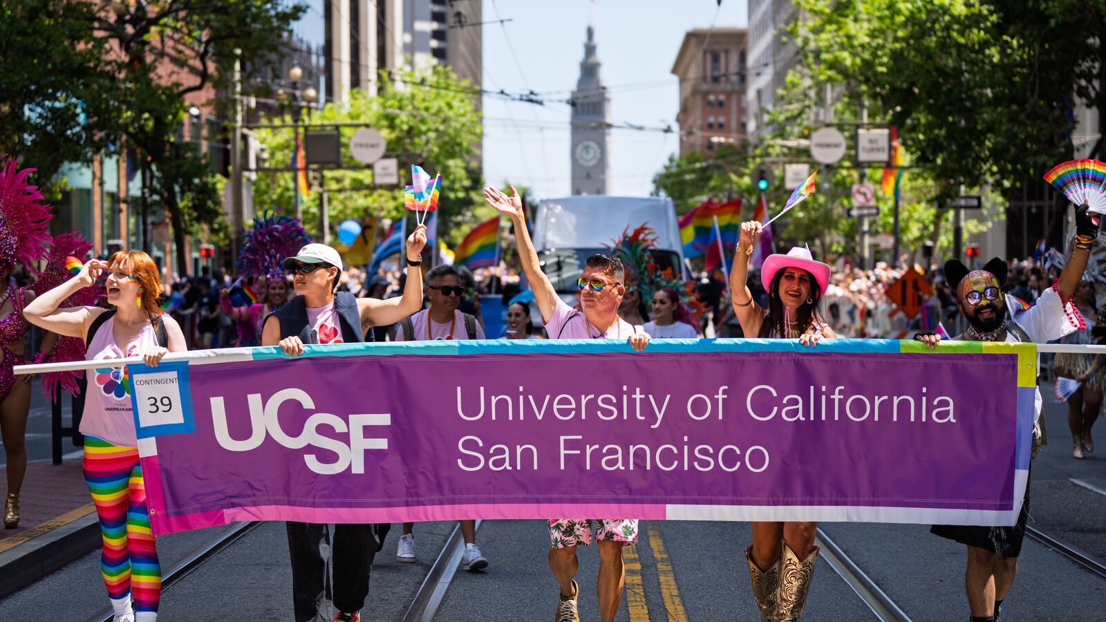 people marching in a parade in downtown San Francisco