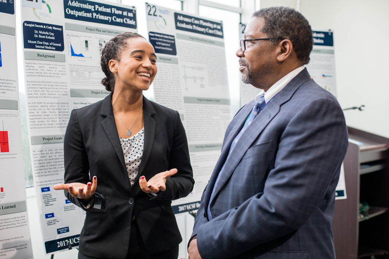 SOM Student and SOM Dean interacting at School of Medicine Poster Session in 2017