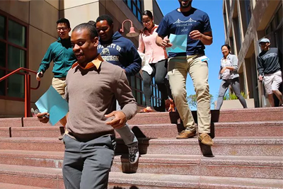 students running down library steps