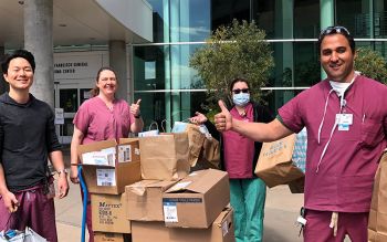 UCSF health care workers receive a donation of personal protective equipment from medical students