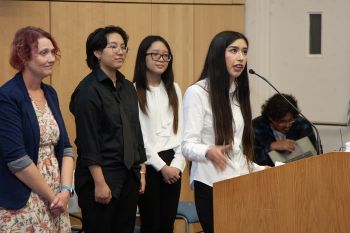 Group of people presenting at podium