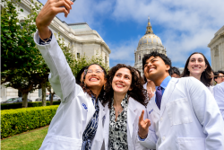 UCSF Medical Students pose for a selfie at the 2026 White Coat Ceremony