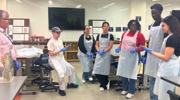 UCSF Post Baccalaureate Students Stand with an Instructor in a Pathology Lab