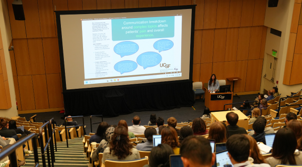 Medical student Natasha Gonzalez presents research at the 2026 UCSF School of Medicine Spring Inquiry Symposium in front of an audience of faculty and peers.